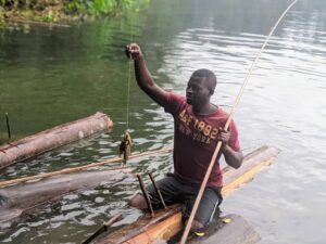 Youths use tree trunks to access Lake Bermin for fishing