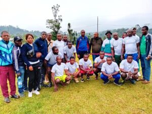 Officials Pose with Male Football Team