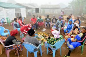 Epenebel women sharing traditional meals