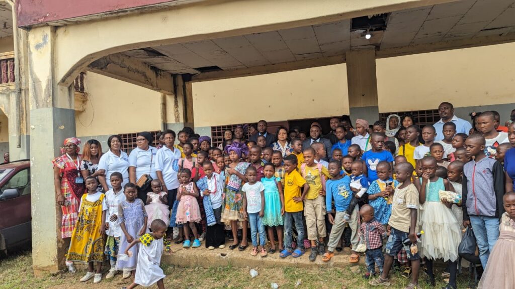 Stakeholders Pose with Children at Ceremony