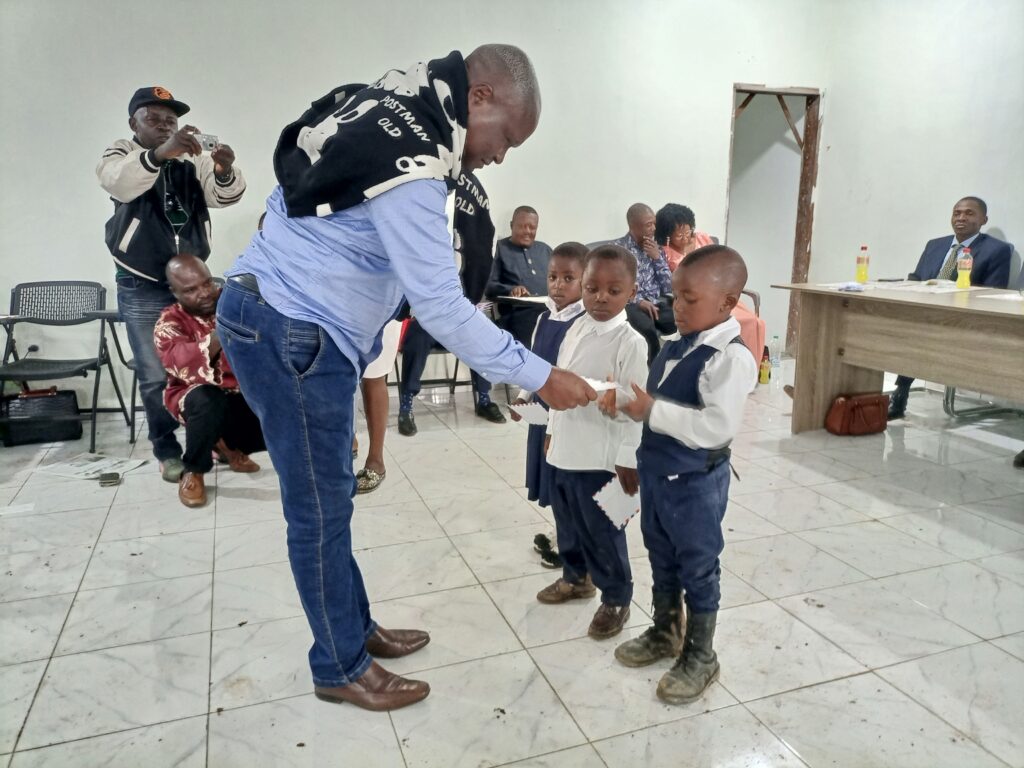 Barrister Ndode Ngube Handing His Prizes to Pupils for Courage and Determination